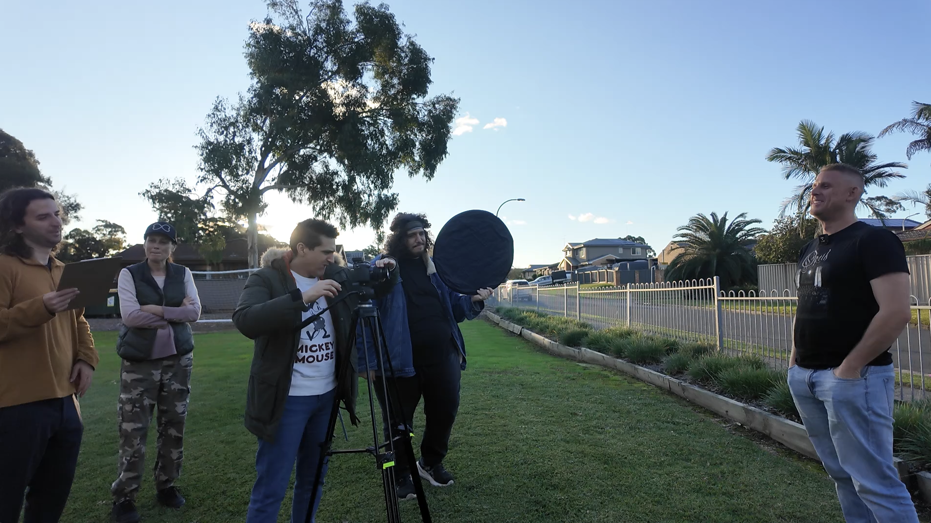 Student film crew capturing an interview outside